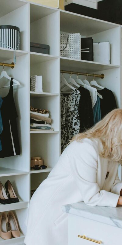 Senior and young woman enjoying a fashion consultation in a stylish boutique wardrobe setting.