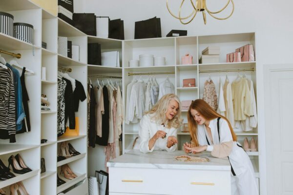 Two women enjoying a luxurious wardrobe setting, showcasing elegance and style.
